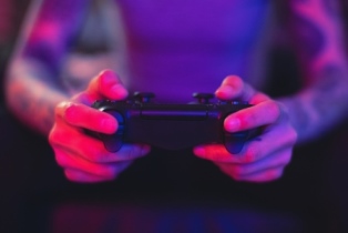 Close up of hands and a game controller