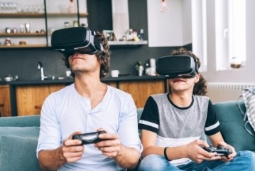 A father and son each with a virtual reality headset on