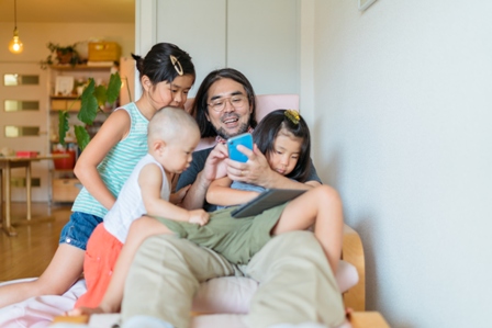 A family with young children look at a screen