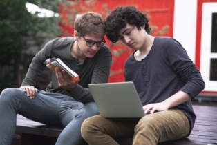 Two boys on laptops