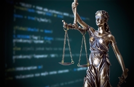 Image of scales of justice with internet screen in background