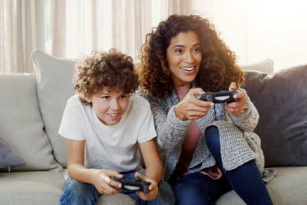 A mom and son playing a video game